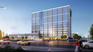 A modern building with a grid of windows, a wide entrance, and a parking lot with cars. - Holiday Inn Express Haiyan by IHG (Jiaxing)