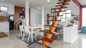 A modern interior with a dining area, kitchen, and living space. - Hilltop Camp, Lembang (Lembang)