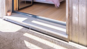 Une chambre à coucher avec un lit, une table de chevet et une fenêtre.