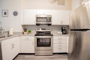 Fridge, microwave, oven, stovetop - CozySuites at The Block -Direct Skybridge Access#1 (Indianapolis)