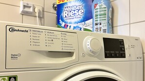 A Bauknecht washing machine with a digital display and control panel. - 90 m2 - Space to Chill & Work & Rest (München)