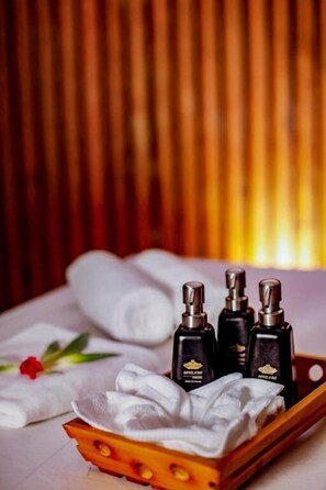 A tray with towels and bottles of toiletries.