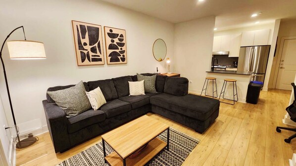Relax in this stylish living space with a comfortable sofa, coffee table, and floor lamp.