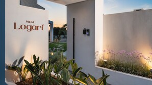 A modern villa named "Villa Logari" with a clean, white exterior and a well-maintained garden. - Sohora Estate up to 14 persons (Chania)