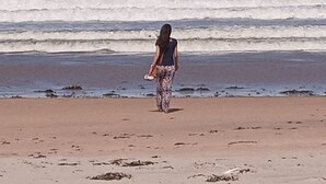 A person walking on a sandy beach with waves in the background. - Spacious Villa on Malindi Beach with pool and restaurant next to Golf course (Malindi)