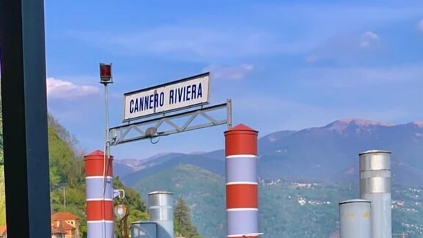 A table set for dining with a view of the water and mountains in the background. - Residenza dei Fiori (Cannero Riviera)