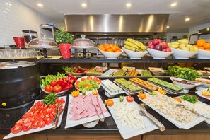 A buffet with various food items including fruits, vegetables, and prepared dishes. - Darkmen Hotel  (Istanbul)