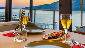 A table set for two with a view of the water and mountains. - KAYA APARTMENTS KALAMAR (Kas)