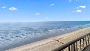 A beach view with a clear sky and calm sea. - Newly Renovated 15th Floor Oceanfront Efficiency (Myrtle Beach)