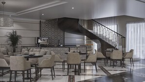 A modern living room with a dining area, a kitchen, and a staircase. - Shaza Regency Plaza (Madinah)