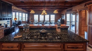 A kitchen with a large island, wooden ceiling, and hanging pendant lights. - Five Star Lodge and Stables is pet friendly with a big mountain view. hot tub, firepits. Ideal for Weddings and Corporate Retreats (Morganton)