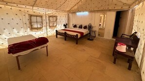 A tented room with a bed, a bench, a chair, and a small table. - Gujarat Resort Jaisalmer (Jaisalmer)