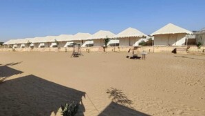 A desert landscape with multiple white tents arranged in rows. - Gujarat Resort Jaisalmer (Jaisalmer)