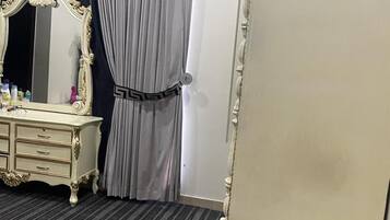Classic design features a large mirror, dresser, and ornate bed with matching headboard.