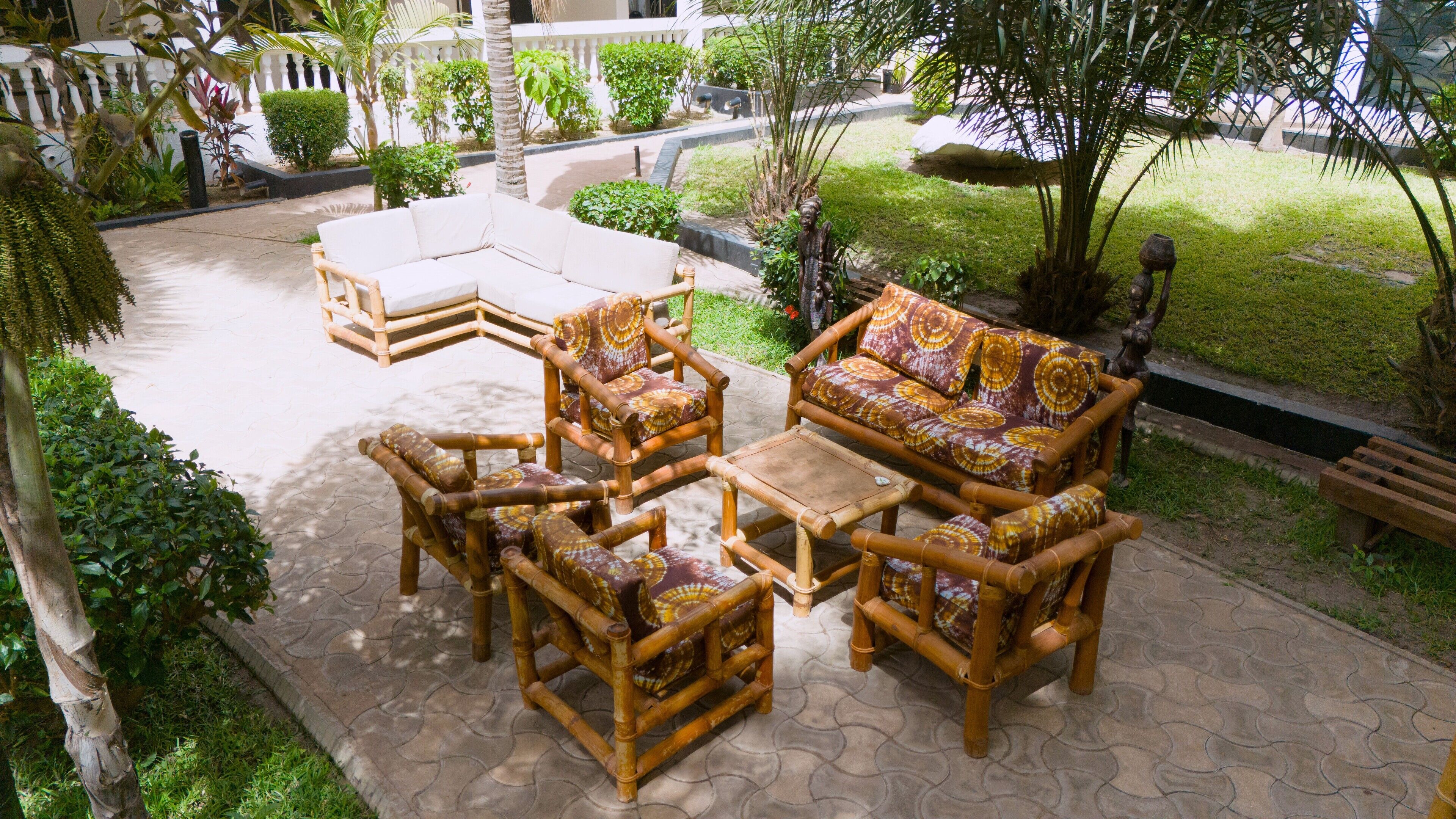 An outdoor seating area with a sofa, chairs, and a coffee table.