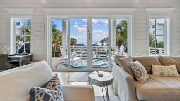 A spacious living area with a large sliding glass door leading to a pool area. - Eastern Lake Beach Access, Heated Pool, 6 Seater Golf Cart!! (Santa Rosa Beach)