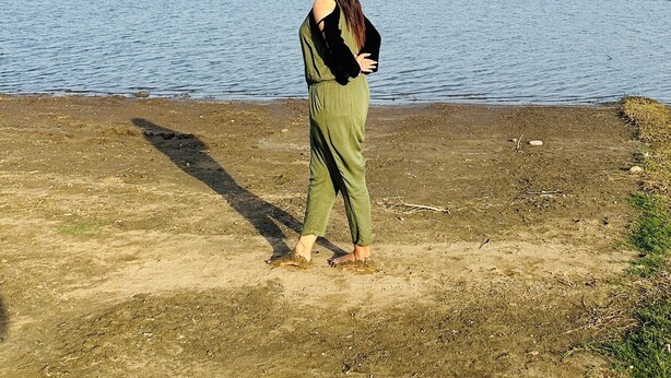 A person standing by a body of water with a clear sky. - Jawai Sanderao Farms (Sumerpur)
