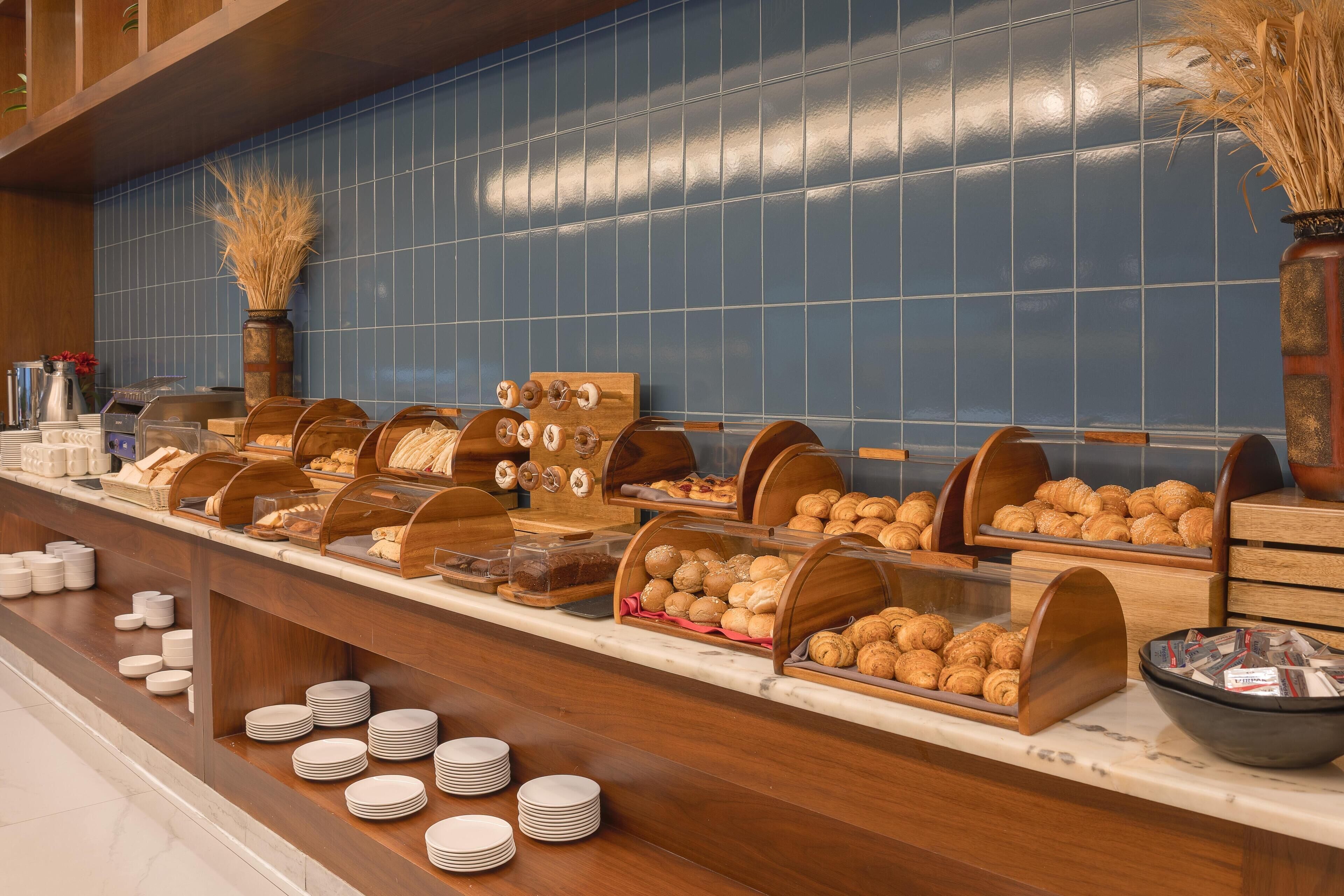 A buffet counter with various food items and serving utensils.