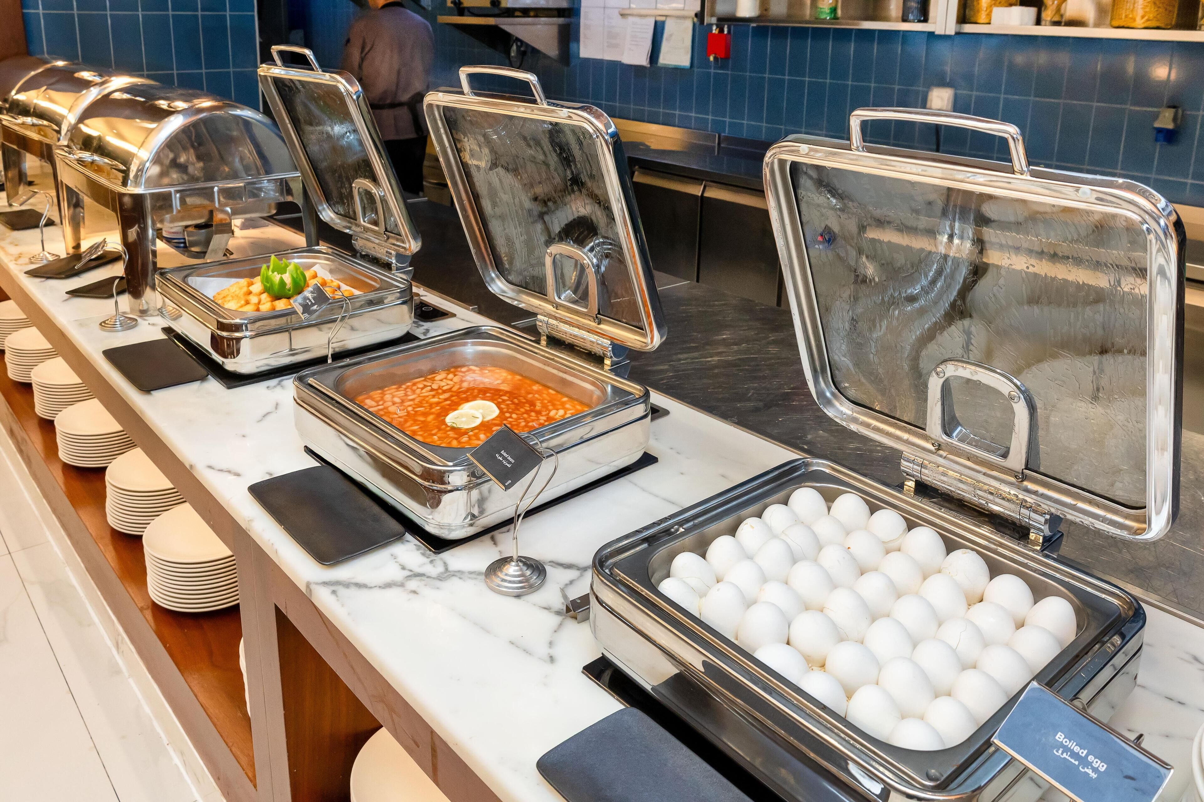 A buffet setup with various food items and a section for boiled eggs.