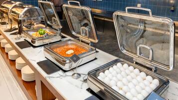 A buffet setup with various food items and a section for boiled eggs.