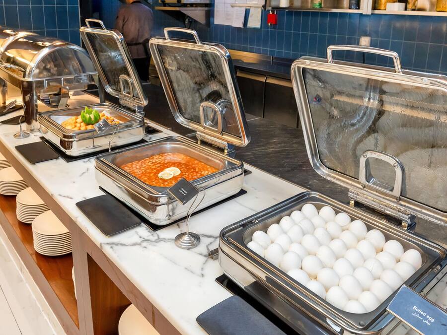 A buffet setup with various food items and a section for boiled eggs.