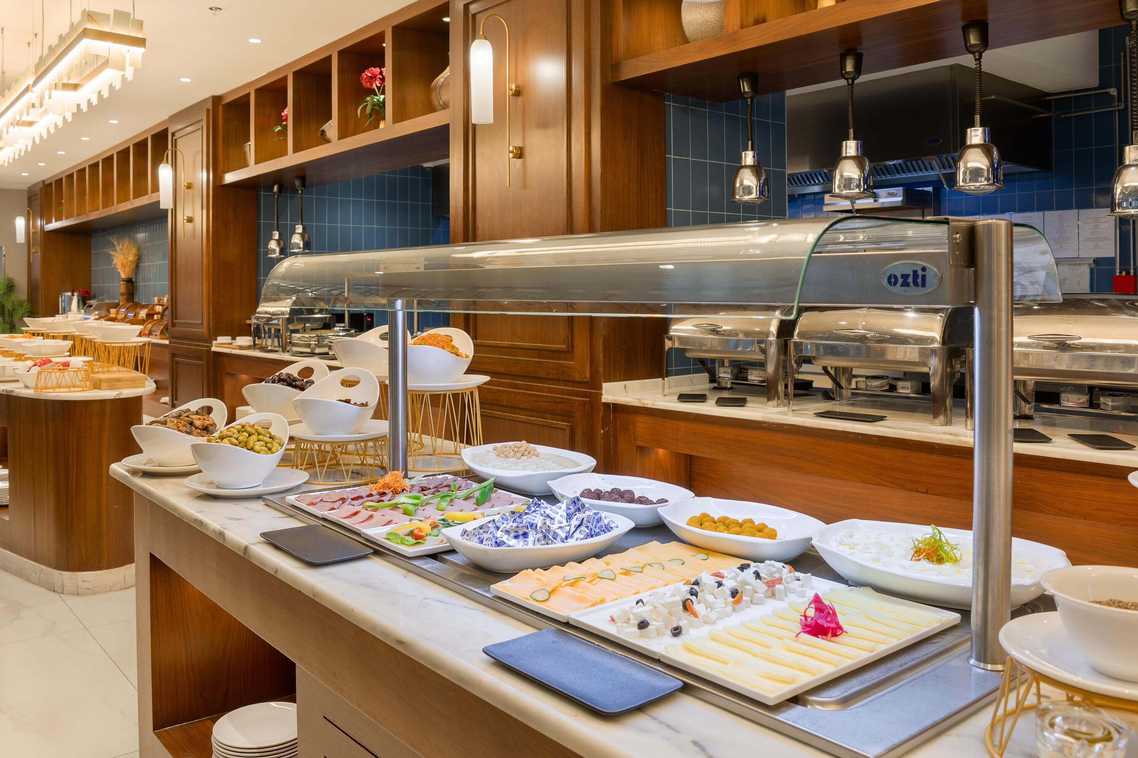 A buffet with various food items and a coffee station.