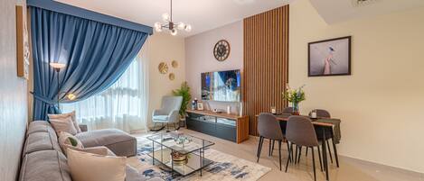 Comfort Apartment | Living area | 65-inch Smart TV with cable channels, Netflix, streaming services