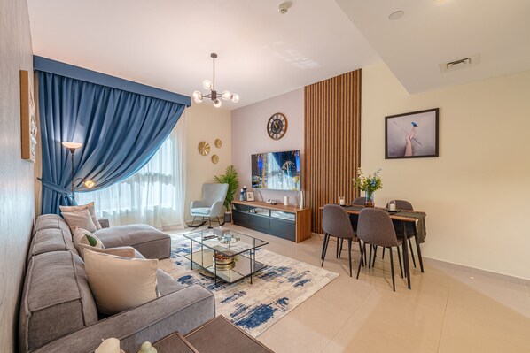 Comfort Apartment | Living area | 65-inch Smart TV with cable channels, Netflix, streaming services - Marco Polo - May Residence 5 (Dubai)