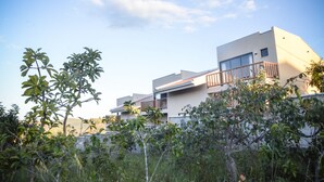 Un edificio moderno de varios pisos con balcones y un cielo despejado.