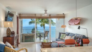 A balcony with a view of the ocean, furnished with wicker chairs, a table, and a sofa. - ENDLESS OCEAN VIEWS- PREMIUM LOCATION & FINISHES-TOP FLOOR-WELL EQUIPPED (Kihei)