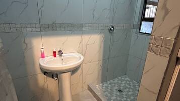 Standard Double Room | Bathroom | Shower, rainfall showerhead, free toiletries, towels