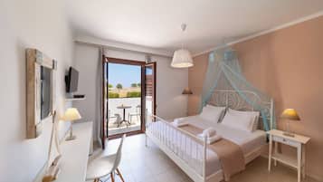 A bedroom with a bed, bedside table, lamp, and a view of the outdoors.