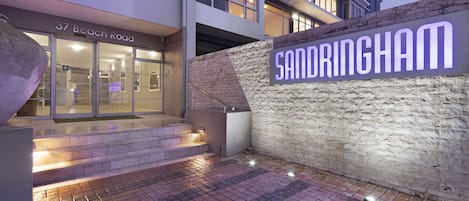 A modern building with a sign reading "37 Beach Road" and "Sandringham."