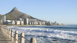 A coastal cityscape with a prominent mountain, a beach promenade, and a view of the ocean. - Sandringham 55 (Cape Town)