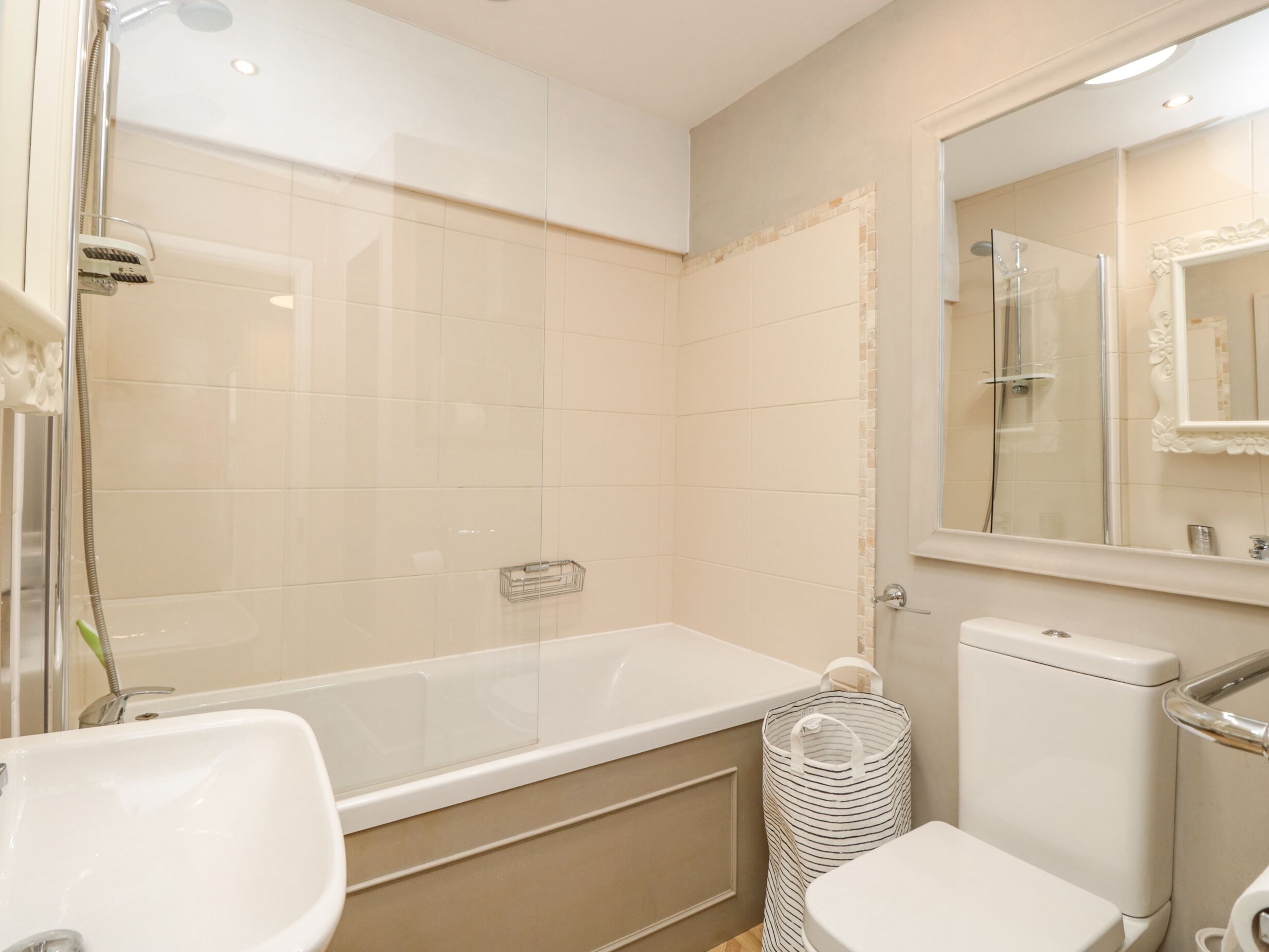 A modern bathroom with a bathtub, toilet, and sink.