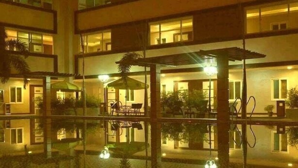 A multi-story hotel with a reflective pool in the foreground. - Inter Park Hotel (Olongapo)
