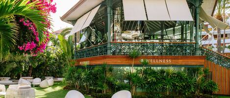 A building with a wooden facade and a sign that reads "MASSAGE & WELLNESS".