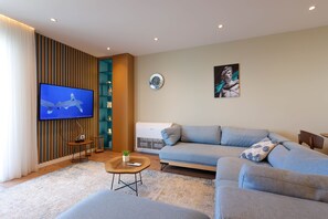 Premium Apartment | Living area | 55-inch Smart TV with digital channels, fireplace - Grandstay Apartments (Durrës)