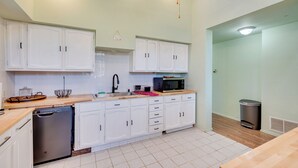 A modern kitchen with white cabinets, a dishwasher, a microwave, and a trash can. - 17 Mi to Town: Peaceful Pet-friendly Golden Cabin! (Golden)