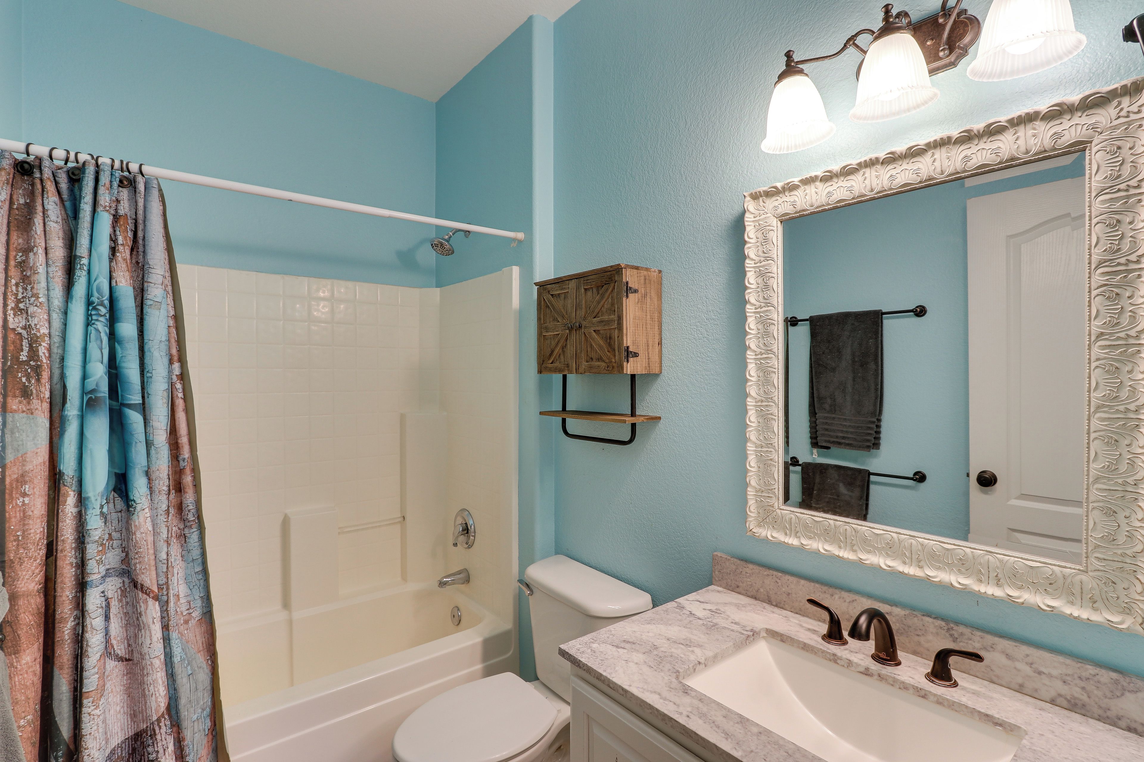 A bathroom with a bathtub, toilet, and sink.