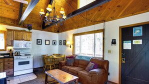 A cozy cabin interior with a kitchen, dining area, and living room. - Hot Tub & Deck: Big Bear City Cabin Near Skiing (Big Bear City)