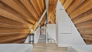 A wooden interior with a staircase leading to a landing. - Weeki Wachee Waterfront-A Frame Stream Dream Cabin (Spring Hill)