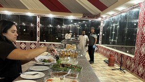 A buffet setup with various dishes and a long serving counter.