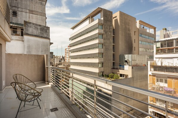 A modern building with multiple floors, balconies, and a view of other buildings. - Báltico Suites  (Buenos Aires)
