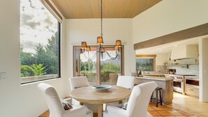 A modern kitchen with a large island, wooden ceiling, and a view of greenery outside. - Red Rock Views: Uptown Sedona Home Near Trails! (Sedona)