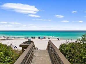 A wooden boardwalk leading to a beach with umbrellas and lounge chairs. - Kenesaw Kabana | Walk to Beach | Sleeps 7 | 2 Pools | Designer Coastal Home (Santa Rosa Beach)