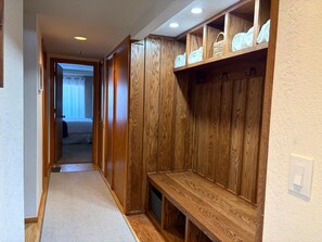Ski mudroom entry — wood-paneled cubbies, boot bench, and folded towels for effortless gear drop-off - KBM Resorts | Ridgepoint | Ski-in/Ski-out access, Common Hot Tub, Summer pool, Tennis, Parking, in Silver Lake Deer Valley! RGT-117 (Park City)