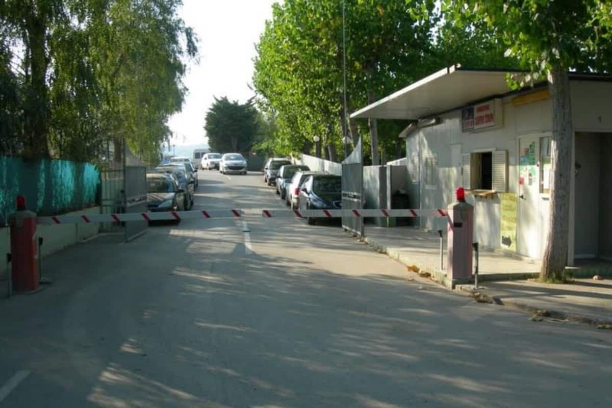 A street with parked cars and a building with a sign.