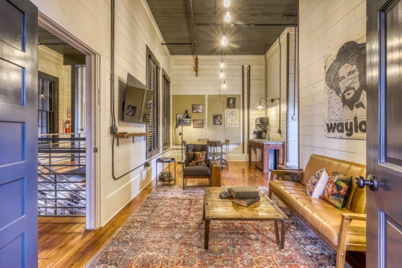 A spacious living area with a sofa, coffee table, and a patterned rug.