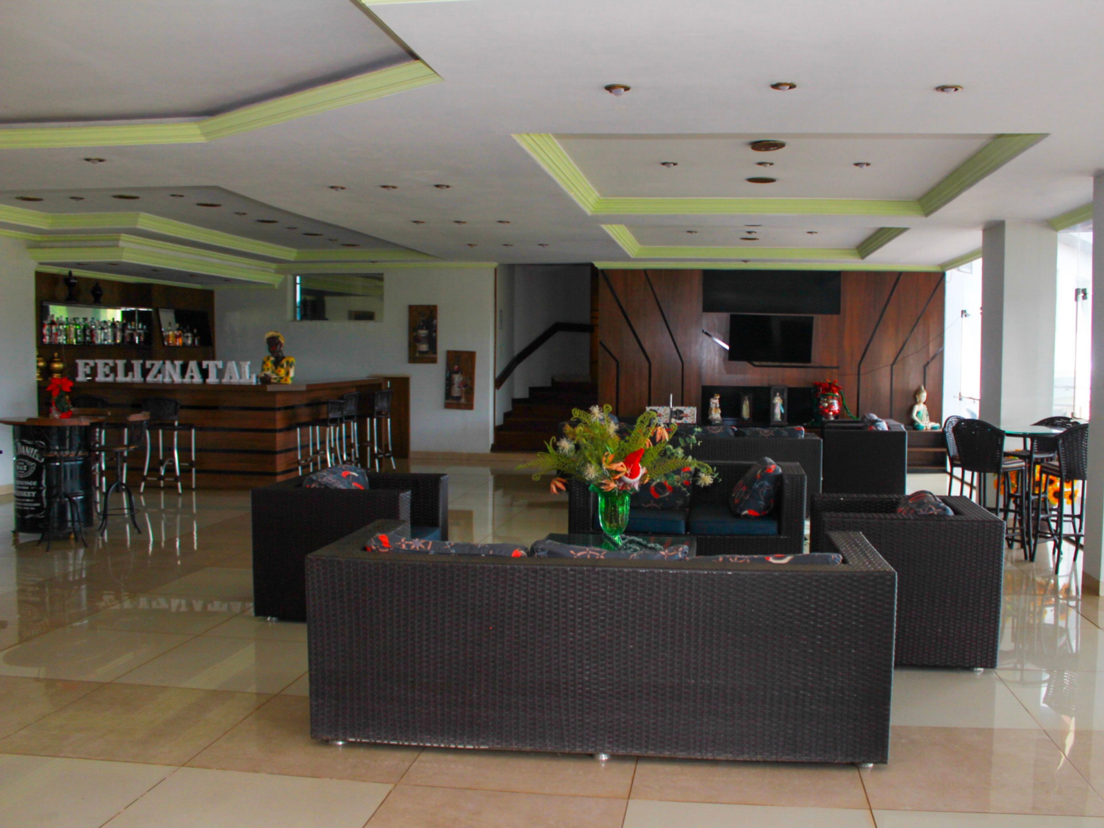 A lobby with a bar area, seating, and a staircase.